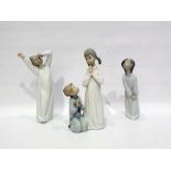 Lladro group of two children saying their prayers and two other Lladro figures of children in