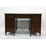Early 20th century mahogany desk with green leatherette inset top, nine assorted drawers, raised