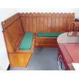 Pine corner pew style seat with slatted backs above lift top seats