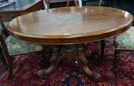 Victorian oval walnut centre table with applied moulded edge, birdcage type pedestal, to four