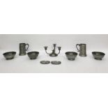 Various pewter items including two tankards with glass bases, a three-branch candelabra of Arts &