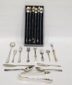 Set of six white metal Oriental cocktail spoons with various charm attachments to the handles, cased