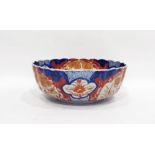 Japanese Imari fluted circular bowl, the interior painted with a jardiniere of flowers on a terrace,