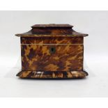 Tortoiseshell two-section tea caddy with bowfront, raised on bun feet  Condition Reportchips and