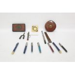 Assorted items to include pens, a South African 1900 Queen Victoria tin box, thermometer, clock, etc