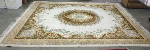 Modern cream ground rug with central brown ground medallion, brown ground spandrels, stepped border,