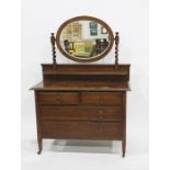 Early 20th century oak dressing chest with oval mirrored superstructure above two short and two long