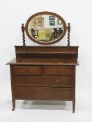 Early 20th century oak dressing chest with oval mirrored superstructure above two short and two long