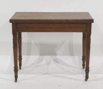 Late 19th/early 20th century folding card table on turned ring supports to brass caps and castors,