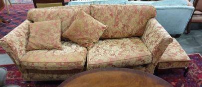 Three-seater and two-seater sofa and matching footstool, all finished in pale gold and red