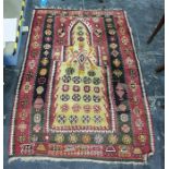 Eastern prayer-type rug in reds, yellows, creams and blacks, 150cm x 103cm