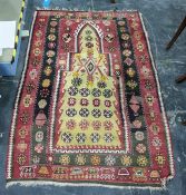 Eastern prayer-type rug in reds, yellows, creams and blacks, 150cm x 103cm