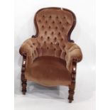 Victorian armchair in brown button-back upholstery, on turned front legs