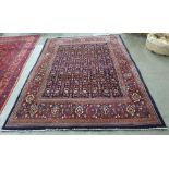 Blue ground rug with allover foliate decoration, on a stepped border, 224cm x 315cm