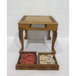 Carved wooden chess table with carved decoration, drawers on either side containing resin chessmen