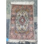 Two Eastern rugs, one white ground with central pink ground stepped foliate medallion, foliate