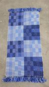 Modern blue ground rug, 130cm x 67cm