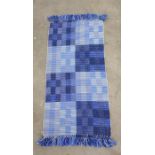 Modern blue ground rug, 130cm x 67cm