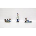 Lladro porcelain figure of a clown, Lladro porcelain figure of a lying boy with book and another