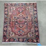 Peach ground rug with central foliate medallion, foliate decorated field, cream ground spandrels,