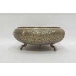 Eastern white metal circular bowl, with foliate surround, raised on cabriole feet, 25cm diameter,