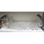 Six various cut glass decanters and a large quantity of cut drinking glasses to include goblets,