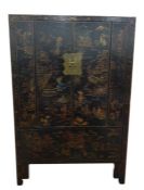 Antique Chinese two-door marriage chest, lacquer decorated on a black ground with assorted figures