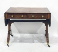 Regency mahogany sofa table with broad kingwood cross-banded border, two frieze drawers with brass