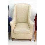 Cream ground armchair with square section front supports