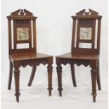 Pair of 19th century mahogany hall chairs with broken arch top rails, the back splats featuring