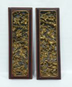 Pair Chinese carved and openwork gilt wood panels of mounted warriors in battle amid prunus trees