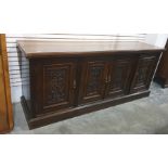 Early 20th century oak sideboard, the rectangular top with moulded edge above four panelled cupboard