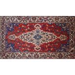 A Persian Bakhtiari carpet, central double medallion with repeating pendent petal motifs on a