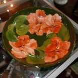 WITHDRAWN - A Moorcroft green glazed bowl, with pink floral design, signed to base, Diameter 26cm