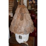 A wooden birdhouse, white painted with slatted roof and finial, H.84cm