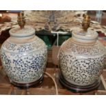 A pair of 20th century Chinese blue and white ceramic table lamps, on stepped circular hardwood