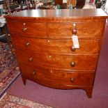 A Victorian mahogany bow front chest, with two short over three longs drawers, raised on splayed