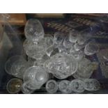 A collection of vintage cut glassware and an assortment of ceramic items, arranged over two boxes