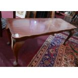 An early 20th century walnut coffee table, on cabriole legs and pad feet, H.42 W.105 D.40cm