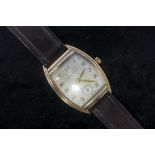 A 1930's gentleman's wristwatch, 14k gold tonneau case with stainless steel back, dial with Arabic