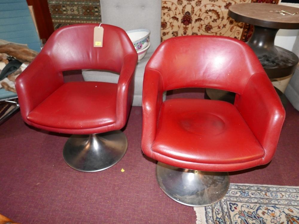 A pair of Johanson, red upholstered, swivel chairs on circular chromed bases
