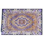 A Persian Qum rug, signed, central floral medallion on a dark brown ground with purple detailing,