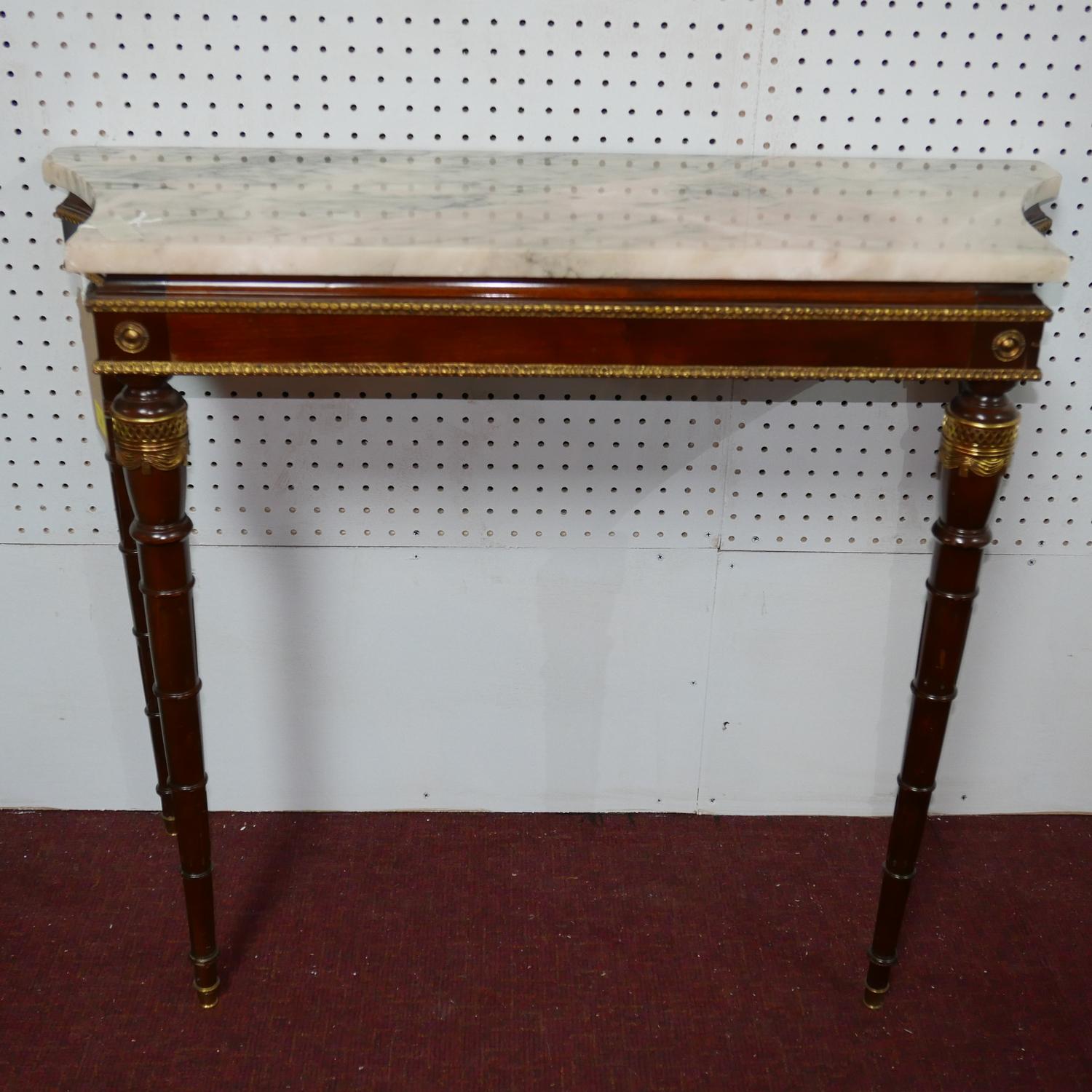 A Louis XVI style mahogany and gilt metal mounted console table, with variegated marble top, on