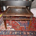 An early 20th century Chinese hardwood low table with a square-shaped top and ribbed side detailing,