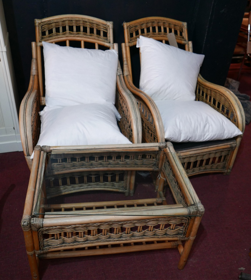 A pair of wicker framed conservatory armchairs, with feather cushions, together with a matching