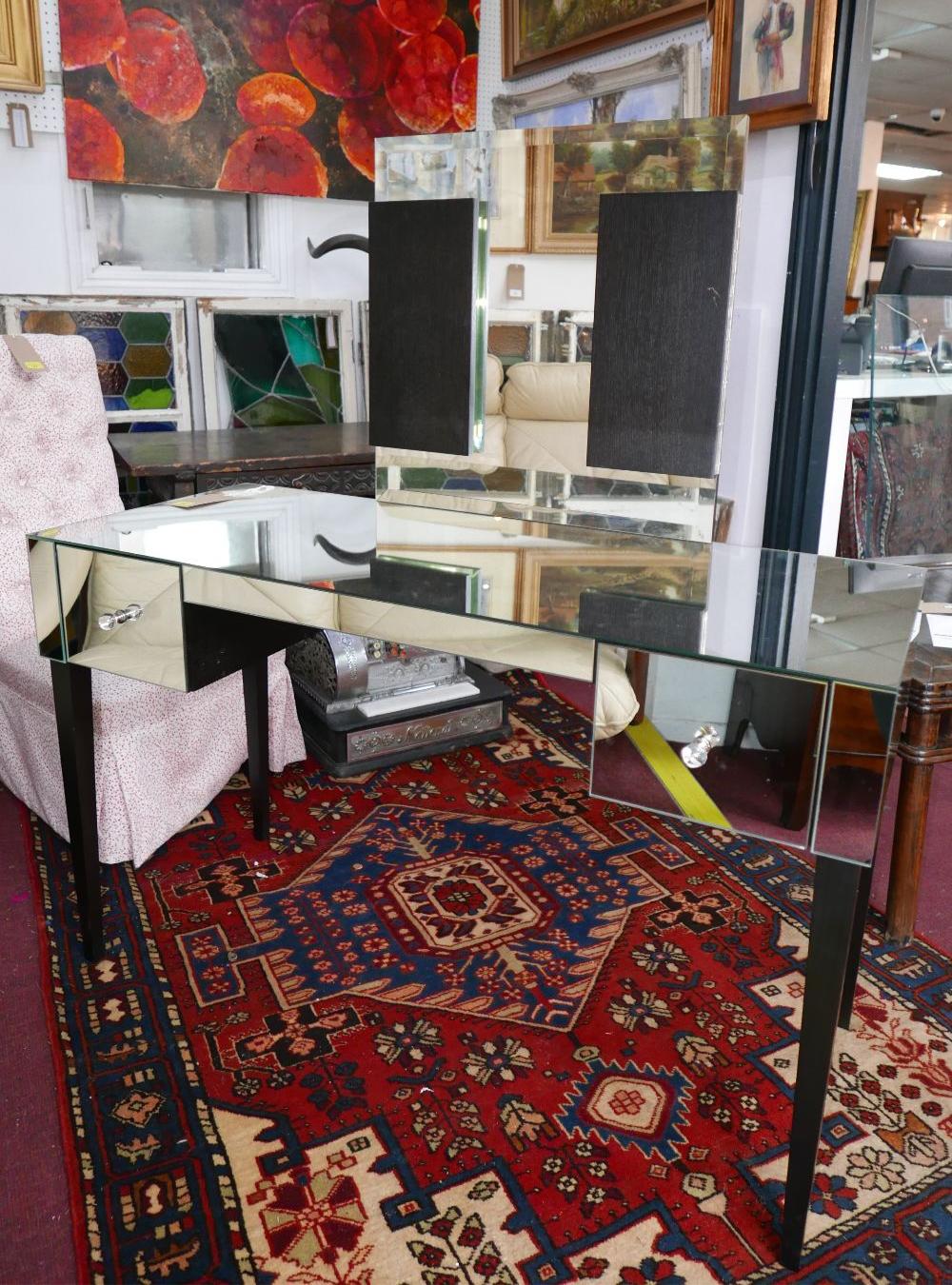 A mirrored dressing table with two upper drawers on tapered dark wooden legs, 75 x 120 x 50cm, and a