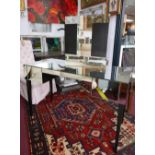 A mirrored dressing table with two upper drawers on tapered dark wooden legs, 75 x 120 x 50cm, and a