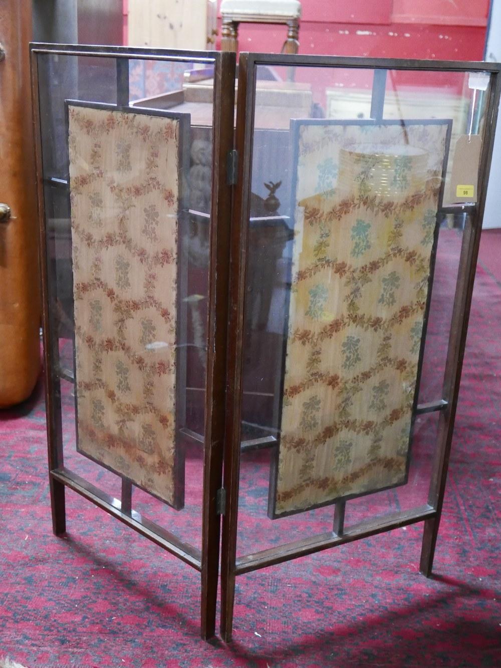 An oak folding fire screen, with two glazed floral embroidered panels, H.107cm