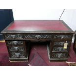 A Victorian carved oak pedestal desk H.69 W.119 D.69cm