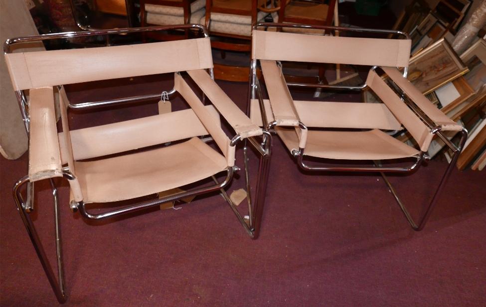 A pair of Wassily chrome framed pink armchairs